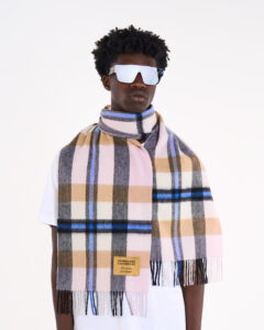 Model styling a pure cashmere scarf with an elegant evening outfit